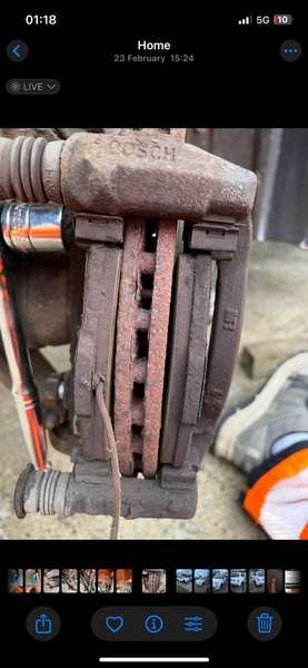 Brake pads worn to bare metal — dangerous condition